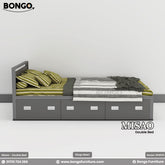 A promotional image for the 'MISAO Double Bed', a modern platform bed with built-in storage. The bed has a dark gray frame and a low headboard. Its base consists of a single row of five storage drawers with white recessed handles. The bed is styled with green striped bedding and a throw blanket.